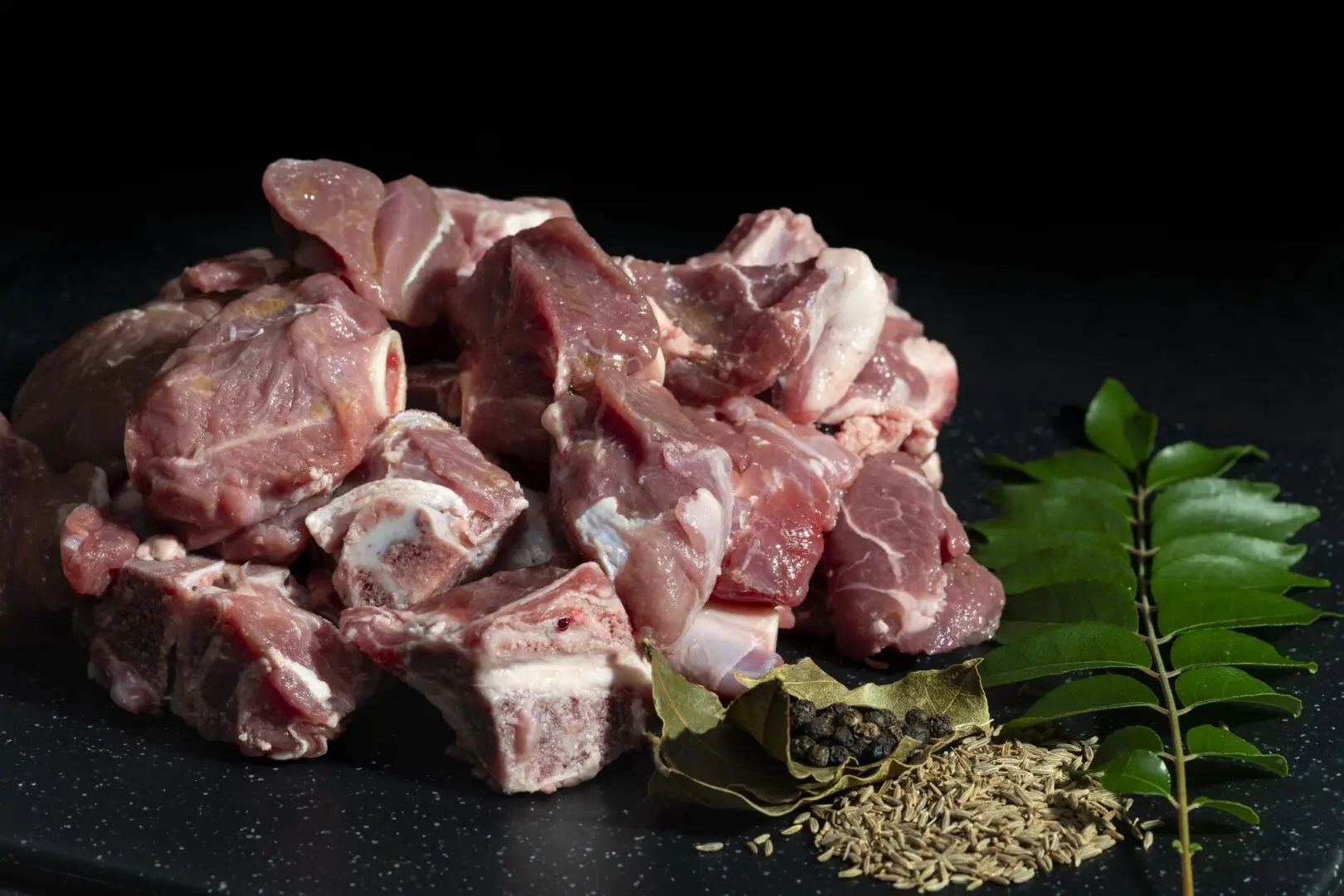 Raw meat with spices and curry leaves.