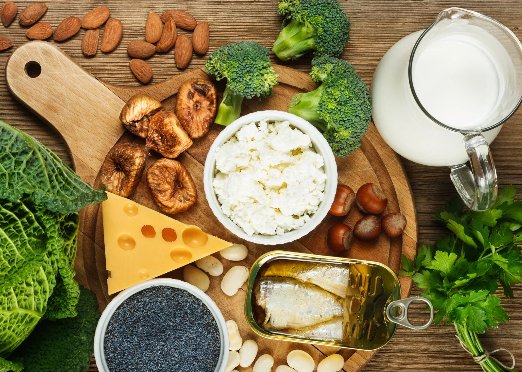 Calcium-rich foods on wooden cutting board.